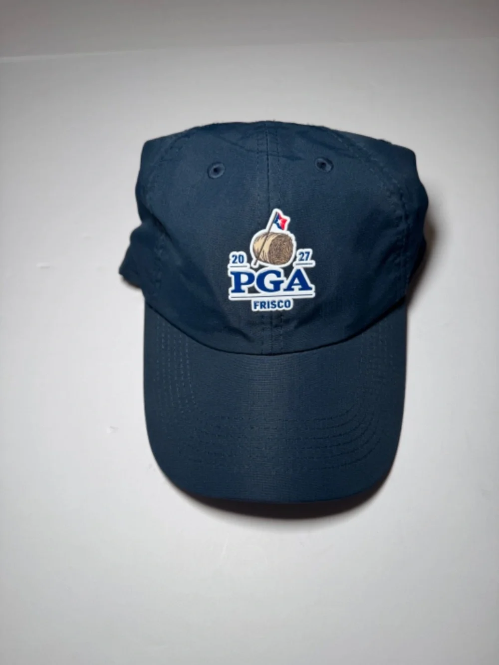 Description: Imperial golf cap in navy blue featuring an embroidered 2027 PGA Fr